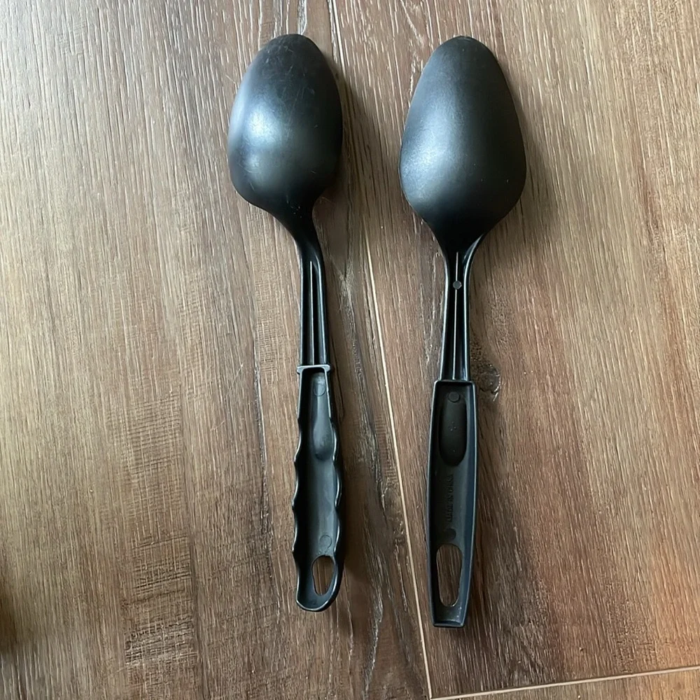 Two large black plastic cooking spoons
